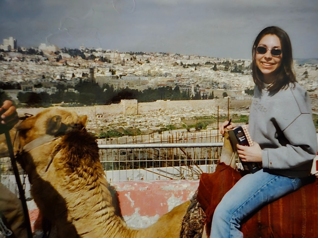Michelle riding a camel during a faith-centered travel experience