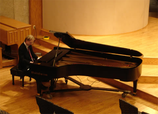 Erik Anderson, a professional music composer, performing piano
