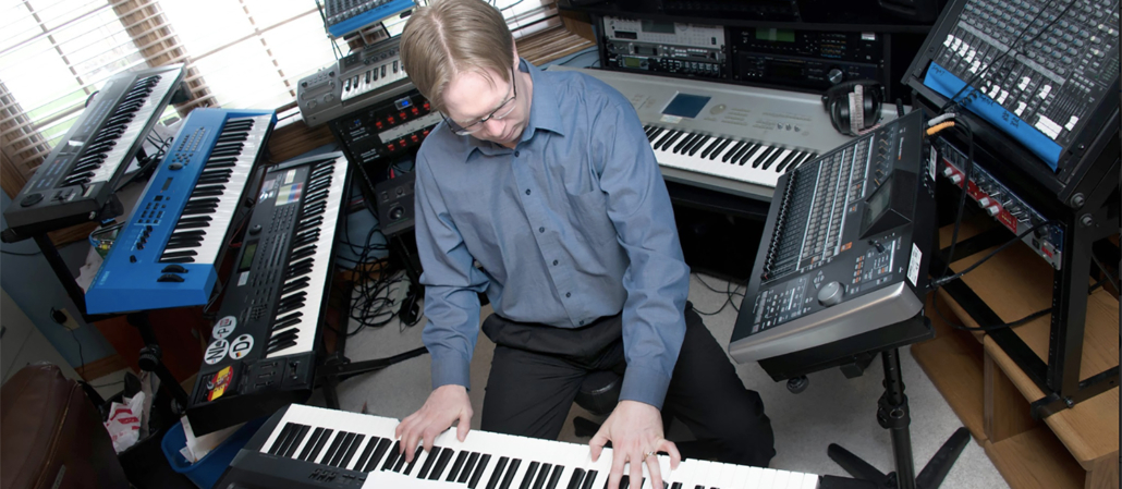 Erik Anderson, a professional music composer, performing keyboard